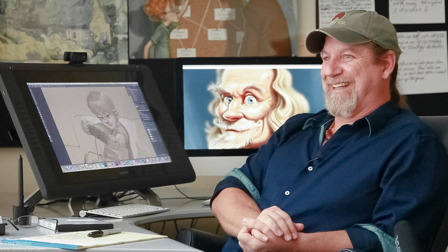 Famous Disney animator of Brother Bear and Lion King fame, Aaron Blaise in front of his art.